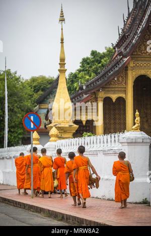 Buddhist monks on the streets of Luang Prabang, Laos. Stock Photo