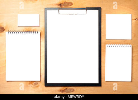 Blank clipboard, business card and notepads on wooden background. Business essentials. Stock Photo