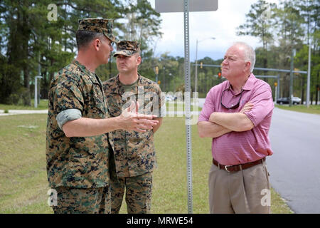 Lt. Col. Jeremy Winters, left, and Sgt. Maj. Marinica Ariton center, welcome Marine Mark Carter to the Marine Air Support Squadron 1 facilities at Marine Corps Air Station Cherry Point, N.C., April 14, 2017. Cartrer was accompanied by Will Lewis, mayor of Havelock during a tour of MASS-1, Marine Air Control Group 28, 2nd Marine Aircraft Wing. Carter is the general manager of Wells Global and was assigned to MASS-1 during his time in the Corps as a sergeant. Winters is the commanding officer of MASS-1 and Ariton is the Squadron sergeant major. Stock Photo