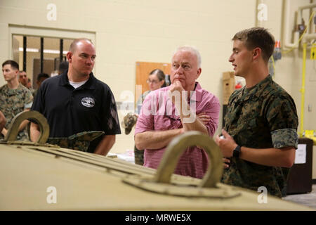 Will Lewis, mayor of Havelock, left, and Marine Mark Carter are briefed by Cpl. Matthew Foley during a tour at Marine Corps Air Station Cherry Point, N.C., April 14, 2017. Carter and Lewis toured the Marine Air Support Squadron 1 facilities and had a first-hand look at the squadron’s mission. MASS-1, Marine Air Control Group 28, 2nd Marine Aircraft Wing, is responsible for the planning, receiving, coordination and processing of requests for direct or close air support. Foley is a communications maintenance noncommissioned officer with the  unit. Stock Photo