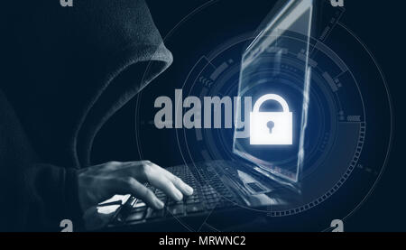 Internet network and data security. Hacker in black hoodie using computer laptop Stock Photo