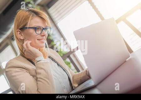 girl working on a laptop at a restaurant Stock Photo - Alamy