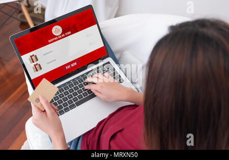 Close up woman sitting use credit card shopping online on laptop computer in add to cart function webpage at home,Digital marketing concept.digital li Stock Photo