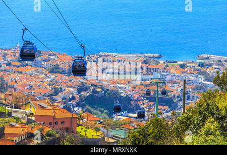 Traditional cable car transporting tourists above Funchal city of Madeira island, Portugal Stock Photo