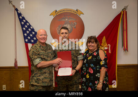 U.S. Marines, family and friends gather for Maj. Gen. Robert F. Castellvi's promotion ceremony on Camp Lejeune, N.C., 11 July, 2017. Castellvi was promoted from Brigadier General to Major General by Maj. Gen. Walter L. Miller. (U.S. Marine Corps photo by Lance Cpl. Taylor N. Cooper) Stock Photo