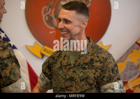 U.S. Marines, family and friends gather for Maj. Gen. Robert F. Castellvi's promotion ceremony on Camp Lejeune, N.C., 11 July, 2017. Castellvi was promoted from Brigadier General to Major General by Maj. Gen. Walter L. Miller. (U.S. Marine Corps photo by Lance Cpl. Taylor N. Cooper) Stock Photo