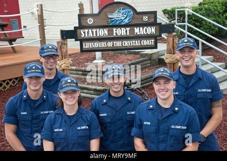 Petty Officer 3rd Class Michael Sparks (left to right), Fireman Samuel Ragsdale, Fireman Jordan Markland, Petty Officer 2nd Class Tyler McGregor, Petty Officer 2nd Class Zane Hutson and Seaman Crewe Goralski reunite at Station Fort Macon, North Carolina, July 10, 2017. Sparks and Ragsdale were rescued by the others July 6 after a diving incident where the two were stranded eight miles off Atlantic Beach. (U.S. Coast Guard photo by Petty Officer 2nd Class Nate Littlejohn) Stock Photo