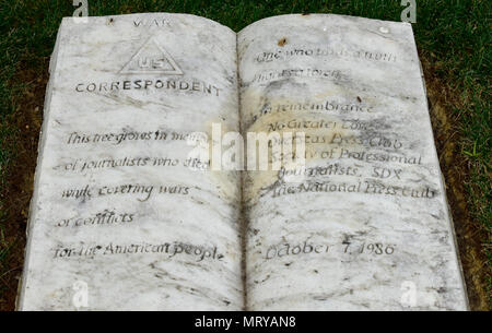 The War Correspondents Memorial stone at Arlington National Cemetery on July 11.    Inscription on the stone reads:    'WAR CORRESPONDENT    This tree grows in memory  of journalists who died  while covering wars  or conflicts  for the American people.    One who finds a truth lights a torch.  In remembrance  No Greater Love  Overseas Press Club  Society of Professional  Journalists, SDX  The National Press Club    October 7, 1986'  (U.S. Army National Guard photo by Spc. Stephen Wright) Stock Photo