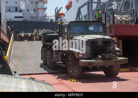 A U.S. Marine Corps AMK26 Recovery Truck drives off a ramp during exercise Pacific Horizon 2017 aboard the USNS John Glenn, July 7, 2017. Pacific Horizon 2017 is a Maritime Prepositioning Force (MPF) exercise designed to train I Marine Expeditionary Force (MEF) and components of Naval Beach Group 1 (NBG-1) Marines and Sailors on arrival and assembly operation as well as follow-on Marine Air Ground Task Force actions to ensure that the right equipment, supplies and tools get to the right people to be employed in a crisis response, humanitarian assistance or amassing combat power ashore from sea Stock Photo