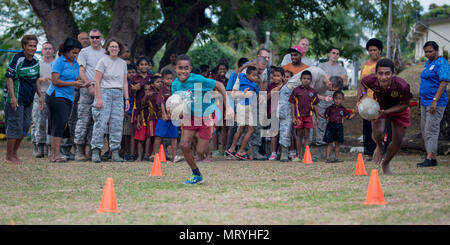 Two Fijian boys race against time during an obstacle course competition where they paired up with a U.S. service member on each team and fought the clock to get the whole team through the course before time ran out during a sports day community engagement activity at the Lautoka School for Special Education in Lautoka, Fiji, July 14, 2017. The service members are in Lautoka as part of Pacific Angel 2017 where they’re working with the Fijian government to provide humanitarian assistance and subject matter expert exchanges July 11 to 24. (U.S. Air Force photo by Tech. Sgt. Benjamin W. Stratton) Stock Photo