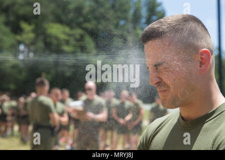 A student attached to Marine Corps Embassy Security Group is sprayed with oleoresin capsicum (OC) spray during OC training on Marine Corps Base Quantico, Va., July 7, 2017. Students are sprayed with OC as a part of their training to become Marine Security Guards. (U.S. Marine Corps photo by Lance Cpl. Yasmin D. Perez) Stock Photo