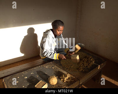 Woman of the Betsileos people producing handmade paper with flowers, Ambalavao, Madagascar Stock Photo