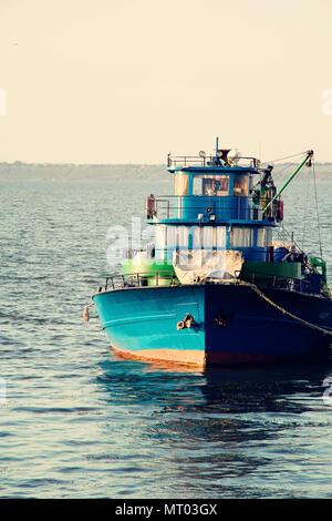 Large fish processing boat in the deep water dock on a sunny summer day. photo Stock Photo