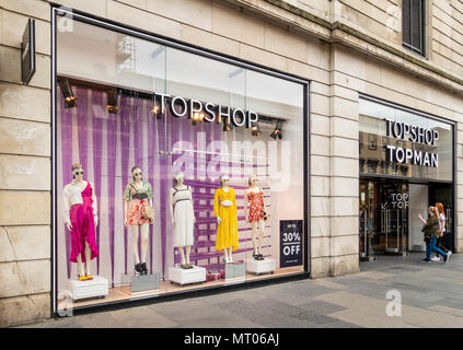 Two young women entering the branch of TopShop, a fashion retail shop in Argyle Street, central Glasgow, Scotland, UK Stock Photo