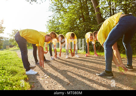 Young people are doing a teambuilding exercise together outdoors in nature Stock Photo