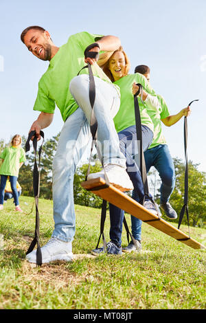 Young sporty team is having fun doing an exercise for coordination and teamwork Stock Photo