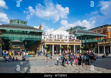 Covent Garden Piazza London - a popular London shopping and tourist site in Central London with animated street entertainment Stock Photo