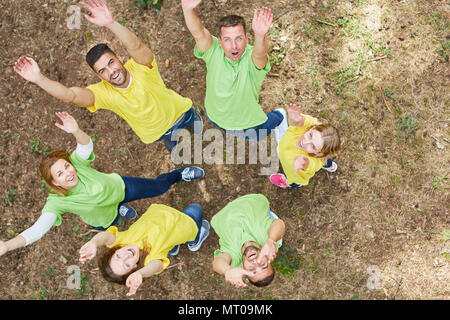 Young people are doing an exercise for team spirit and teambuilding in nature Stock Photo