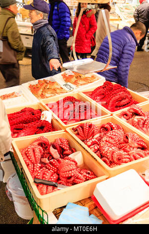 Indoor Omicho Ichiba, Omicho Market, est mid 18th century, largest fresh food market in Kanazawa, Japan. Red and bloodied octopus in boxes on stall. Stock Photo