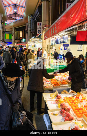 Indoor Omicho Ichiba, Omicho Market, est mid 18th century, largest fresh food market in Kanazawa, Japan. View along stall with oranges and fruits. Stock Photo