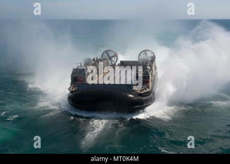 ATLANTIC OCEAN (July 14, 2017) A landing craft air cushion, assigned to Assault Craft Unit 4, approaches the amphibious assault ship USS Iwo Jima (LHD 7) during well deck operations. Iwo Jima is underway with Amphibious Squadron (PHIBRON) FOUR and the 26th Marine Expeditionary Unit (MEU) conducting PHIBRON-MEU Integrated Training in preparation for their upcoming deployment. (U.S. Navy photo by Mass Communication Specialist Seaman Kevin Leitner/Released) Stock Photo