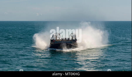 ATLANTIC OCEAN (July 14, 2017) A landing craft air cushion, assigned to Assault Craft Unit 4, approaches the amphibious assault ship USS Iwo Jima (LHD 7) during well deck operations. Iwo Jima is underway with Amphibious Squadron (PHIBRON) FOUR and the 26th Marine Expeditionary Unit (MEU) conducting PHIBRON-MEU Integrated Training in preparation for their upcoming deployment. (U.S. Navy photo by Mass Communication Specialist Seaman Kevin Leitner/Released) Stock Photo