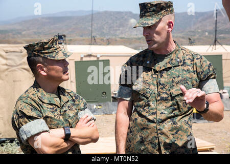 Lt. Col. Richard M. Martin, commanding officer for 1st Marine Raider Support Battalion, U.S. Marine Corps Forces, Special Operations Command and Maj. Gen. Daniel Yoo, commander of Special Operations Command Pacific discuss special operations mission support during a tour of 1st MRSB’s Tactical Readiness Exercise aboard Marine Corps Base Camp Pendleton, Calif., July 10. (U.S. Marine Corps photo by Sgt. Salvador R. Moreno, released) Stock Photo