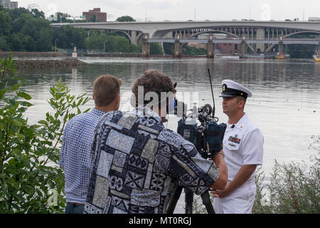 170718-N-CU914-011 MINNEAPOLIS (July 18, 2017) –Chief Navy Diver Noah Gottesman, a native of Gaithersburg, Md., reflects back to ten years ago when he was called to assist local, state and federal authorities in finding missing victims in the wake of the bridge collapse while he was attached to Mobile Diving and Salvage Unit (MDSU) 2. Gottesman returned to the area for an interview with NBC KARE 11 reporter Kent Erdahl, during Minneapolis/St. Paul Navy Week. Navy Week programs serve as the Navy's principal outreach effort into areas of the country without a significant Navy presence, with 195  Stock Photo