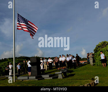 RAIDR 21 refers to a B-52 Stratofortress training mission accident on July 21 2008 near Guam involving six aircrew members from the 20th Expeditionary Bomb Squadron. The archival image documents attendees assembled at the RAIDR 21 monument in Adelup Guam during the memorial ceremony on July 21 2017. Stock Photo