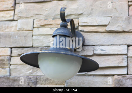 Old lamp on a brick wall, close-up Stock Photo