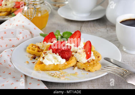 Delicate, melting  mouth-watering  Belgian waffles with whipped cream, strawberries, flavored with peanuts and honey. What could be better for breakfa