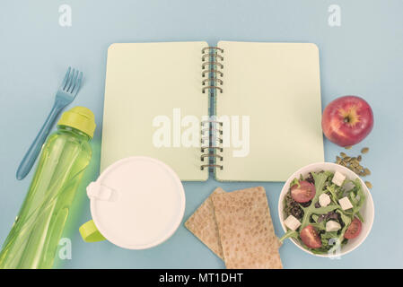 A set of useful products, cherry Tomato, apple fruit Seeds Plastic Tableware White Flowers Fresh Salad top View Copy Space for Text Flat Lay Stock Photo