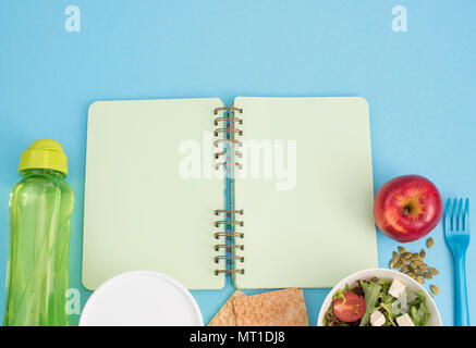 A set of useful products, cherry Tomato, apple fruit Seeds Plastic Tableware White Flowers Fresh Salad top View Copy Space for Text Flat Lay Stock Photo