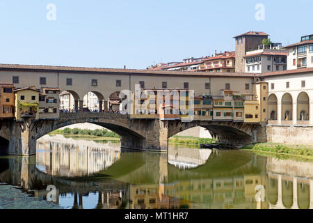 The historic Ponte Vecchio, the oldest bridge over the Arno River in Florence, Italy, featuring its famous shops built along the bridge Stock Photo