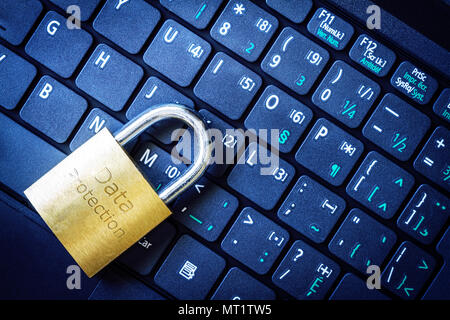 Golden padlock on computer laptop keyboard with Security word engraved. Concept of Internet security, data privacy, cybercrime prevention. Stock Photo