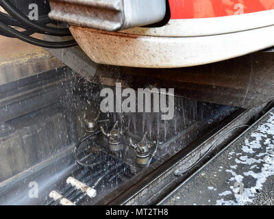 28 May 2018, Berlin, Germany: Underfloor cleaning for a regional train in the car wash of the DB Regio workshop in Berlin-Lichtenberg. Up to 12 trains can be cleaned daily. In the year about 220 000 meters of train are washed. Photo: Bernd Settnik/dpa-Zentralbild/dpa Stock Photo