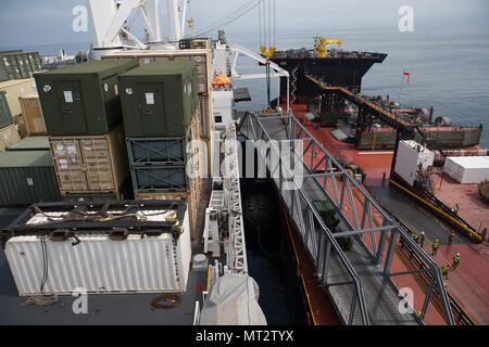 A High Mobility Multipurpose Wheeled Vehicle (HMMWV) with an M149A2 Water Trailer in tow drives up a ramp from the USNS John Glenn onto the USNS Dahl during Pacific Horizon 2017, July 18 2017. Pacific Horizon 2017 is a Maritime Prepositioning Force (MPF) exercise designed to train I Marine Expeditionary Force (MEF) and components of Naval Beach Group 1 (NBG-1) Marines and Sailors on arrival and assembly operation as well as follow-on Marine Air Ground Task Force actions to ensure that the right equipment, supplies and tools get to the right people to be employed in a crisis response, humanitar Stock Photo