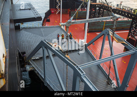 Pacific Horizon 2017 was a Maritime Prepositioning Force exercise held in July 2017 to train Marine and Navy units in coordinated deployment. A ramp connection between USNS John Glenn and USNS Dahl is shown on July 20, 2017, facilitating transfer of vehicles and supplies. The archival image documents shipboard linkage used during arrival and assembly operations. Stock Photo
