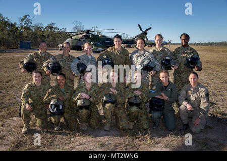 Women pilots and technical maintenance personnel from Australia, New Zealand and the United States are at the Shoalwater Bay Training Area as part of Battle Group Pegasus during Exercise Talisman Saber 2017. From left standing: United States Army Major Alicia McCraw, Lieutenant Colonel Liz Martin, Chief Warrant Officer Two Amy Fox, Australian Army Corporal Michelle McGrath, United States Army Captain Christina Smith, 1st Lieutenant Kacie Ryan and 1st Lieutenant Tiffany Spears. From left knealing: Australian Army Corporal Philipa Finlay, Corporal Betty Latumahina, Lieutenant Bonnie Hunt, Captai Stock Photo