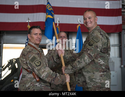 Col. Phillip Noltemeyer, the incoming 455th Expeditionary Mission Support Group commander, receives the 455th EMSG guidon from Brig. Gen. Craig Baker, the 455th Air Expeditionary Wing commander, during a change of command ceremony at Bagram Airfield, Afghanistan, July 20, 2017. During the ceremony, Col. Bradford Coley relinquished command of the 455th EMSG to Col. Phillip Noltemeyer. (U.S. Air Force photo by Staff Sgt. Benjamin Gonsier) Stock Photo