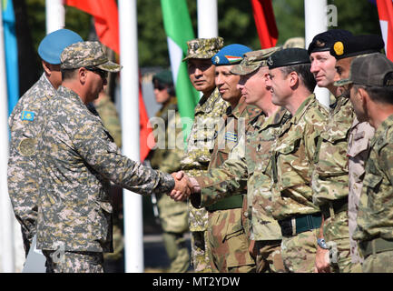 Maj. Gen. Murat Bektanov, Kazakhstan Land Forces commander, greets representatives from each nation participating in Exercise Steppe Eagle 17 during the opening ceremony July 22, 2017, at Illisky Training Center, Kazakhstan. (U.S. Army photo by Capt. Desiree Dillehay, 149th Military Engagement Team) Stock Photo