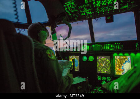 A C-130J Super Hercules pilot with the 36th Airlift Squadron, verifies travel routes during a routine training mission, July 18, 2017, over the Tokyo Metropolitan area, Japan. The routine training included low level flying, simulated heavy cargo drop and night operations including the loading and unloading of the aircraft. (U.S. Air Force photo by Airman 1st Class Donald Hudson) Stock Photo