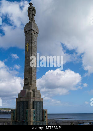 War memorial on Harris promenade to dead of two world wars Douglas Isle of Man silhouetted against blue sky with red poppy wreaths Stock Photo