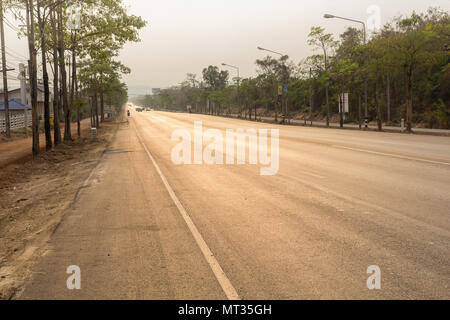 road up hill to the mountain top at at sunny sunset. Stock Photo