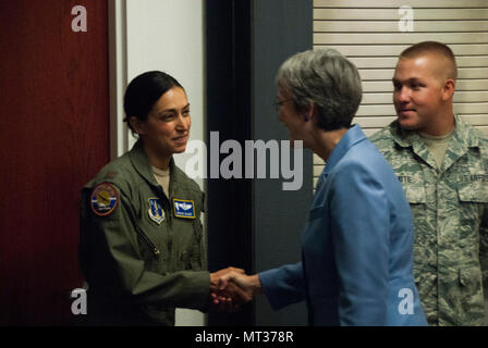 Secretary of the Air Force Heather Wilson stopped in at the Nevada Air National Guard Base, July 25, 2017 on her way to speaking at the Air Force Sergeants Association Conference. On her way to her next destination, Wilson took time to visit with and shared experiences with members of the Nevada Air National Guard. From L to R: 152nd Operations Group Maj. Brooke Magee shakes SecAF Wilson's hand while Senior Airman Codey Beattie listens them exchange greetings. (U.S. Air Force photo/Tech. Sgt. Timothy J. Emerick) Stock Photo