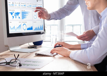 Team of business people discussing digital marketing metrics report and return on investment strategy for advertisement campaign, data analytics dashb Stock Photo