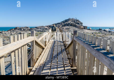 Luderitz, Namibia - July 09 2014: Wooden walkway leading up to Diaz Point on rocks at sea on Luderitz Peninsula Stock Photo