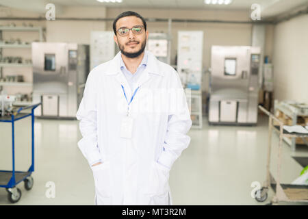 Confident Arabian engineer working in innovative plant Stock Photo