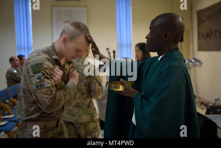 Chaplain (Capt.) John Appiah, 455th Air Expeditionary Wing, blesses a U.S. Army Soldier during a religious service at Hamid Karzai International Airport, Kabul, Afghanistan, July 23, 2017. Religious support teams from Bagram Airfield visit six different locations in Afghanistan where a chaplain is not deployed. (U.S. Air Force photo by Staff Sgt. Benjamin Gonsier)