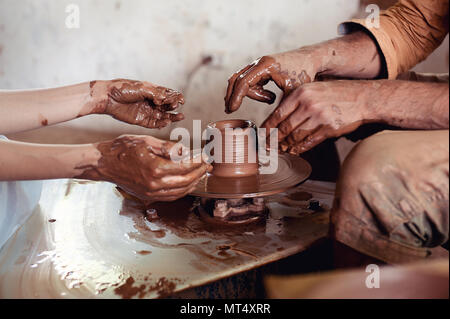 Master class on modeling of clay on a potter's wheel In the pottery workshop Stock Photo
